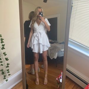 Women’s white dress with V neck and short sleeves with ruffles at the bottom